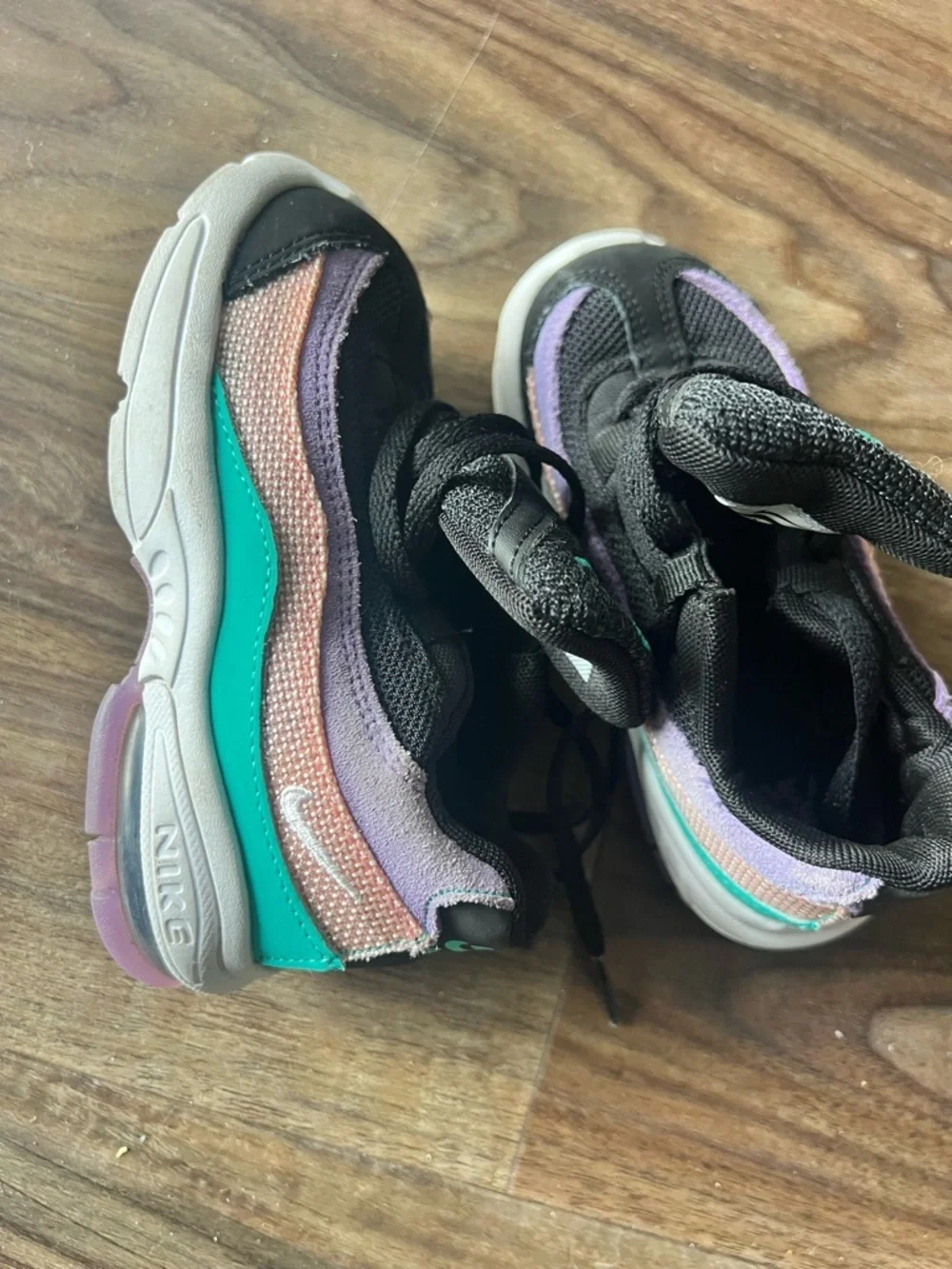 Nike Kids Black Sneakers with Purple Trim and Teal Logo